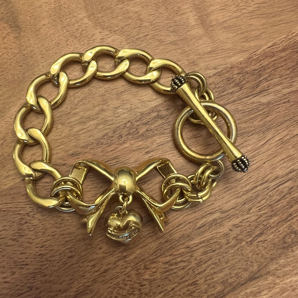 Juicy Couture bow bracelet with a crystal behind the heart.